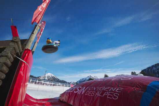 Person flying over an air bag losing their buoy after a Tobogganing jump